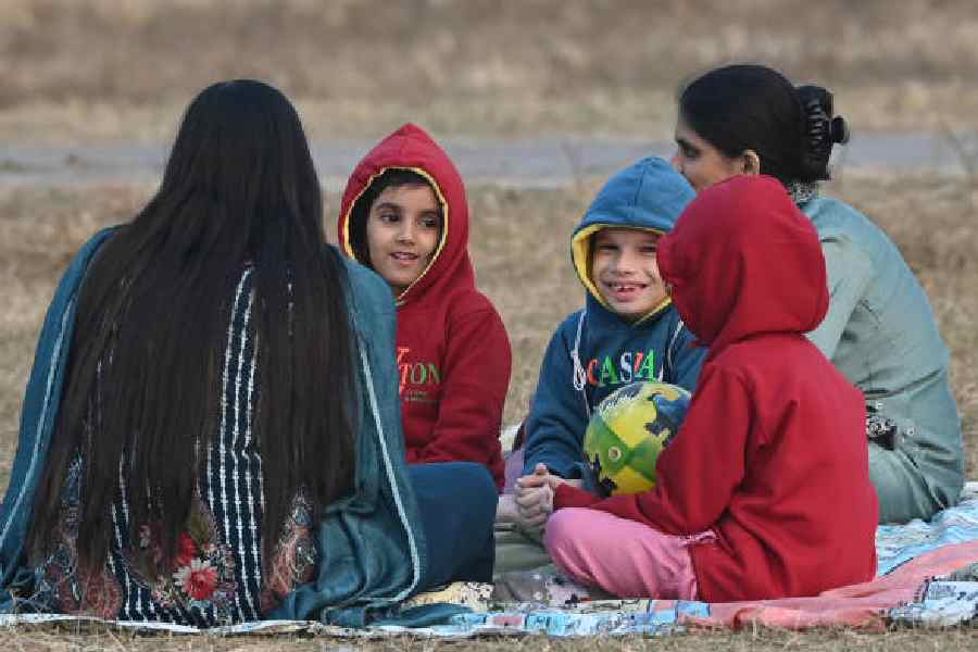 Picnickers on the Maidan in winter wear on Thursday afternoon.