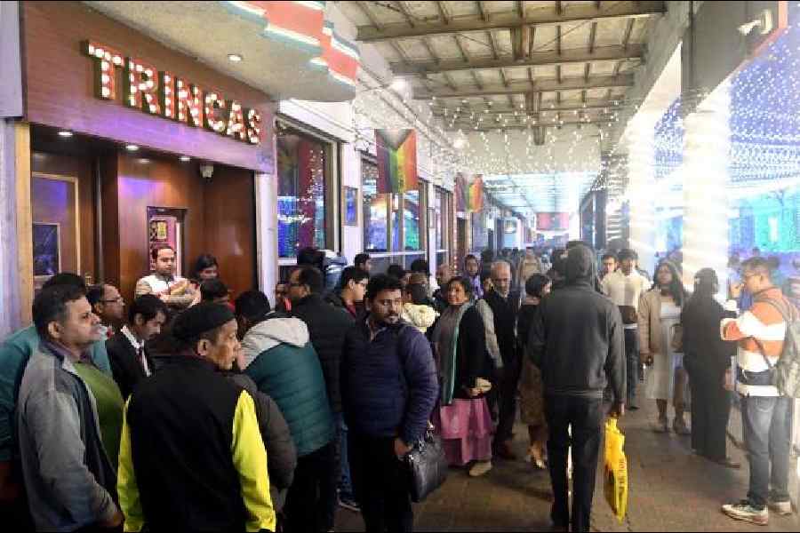 A crowd of diners waits outside Trincas on Park Street on New Year’s Eve.Picture by Sanat Kr Sinha