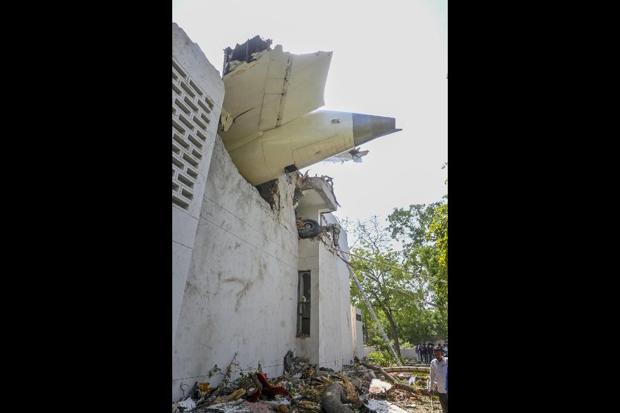 A portion of the crashed Air India plane juts out of a building in Ahmedabad on June 12