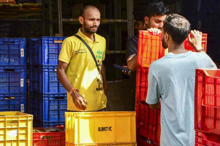 A gig worker outside a grocery store in Mumbai on Wednesday. 