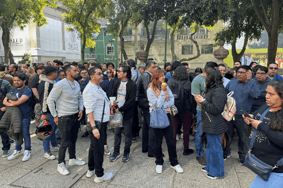 People wait on the street after an earthquake alarm sounded, in Mexico City, Mexico, January 2, 2026.
