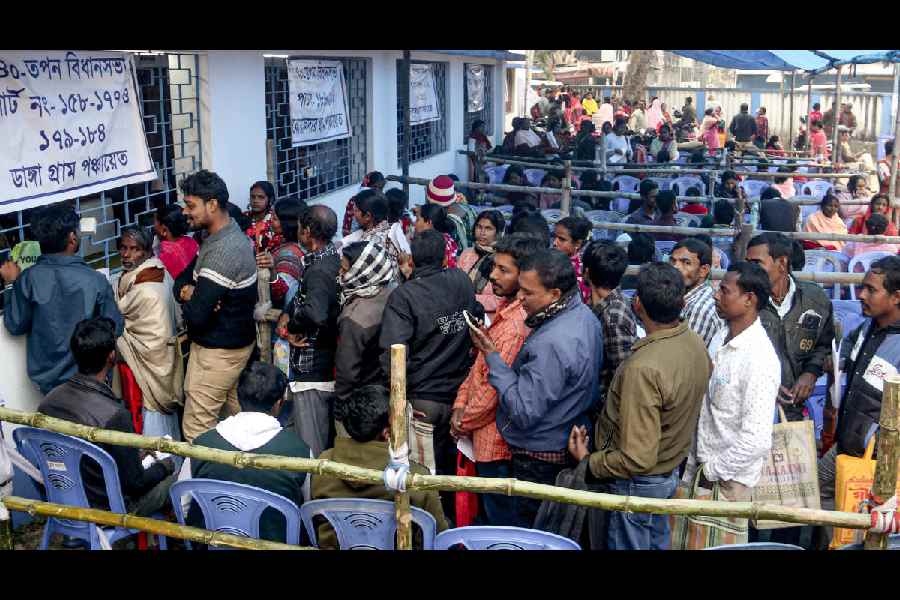 People wait in queues at an SIR hearing centre in Balurghat on Friday.