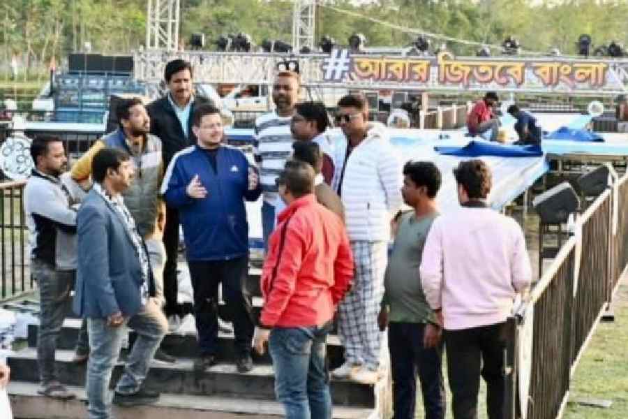 Trinamool MP Ritabrata Banerjee (in blue jacket) oversees the arrangements for Abhishek Banerjee’s interaction, on the Majherdabri tea estate near Alipurduar on Friday