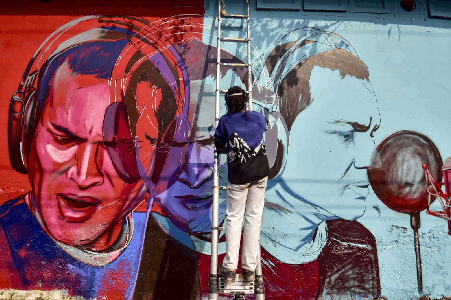 Artist Neelim Mahanta paints a mural of late singer Zubeen Garg as a tribute, in Nagaon district, Assam.