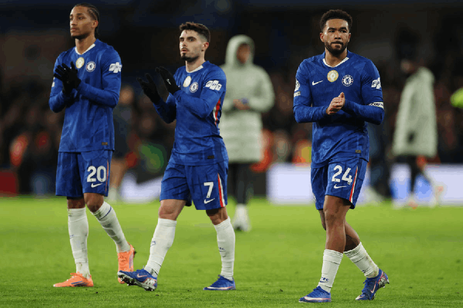Chelsea's Joao Pedro, Pedro Neto and Reece James applaud fans after the match.