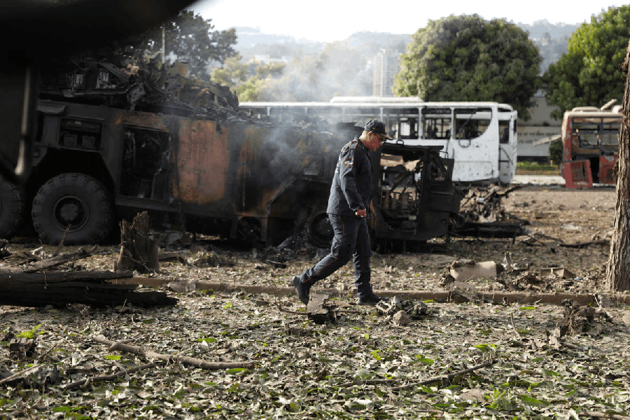 A firefighter walks past a destroyed anti-aircraft unit at La Carlota military air base, after U.S. President Donald Trump said the U.S. has struck Venezuela and captured its President Nicolas Maduro, in Caracas, Venezuela, January 3, 2026.
