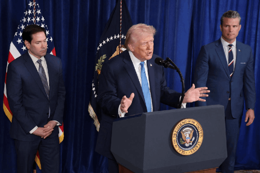 U.S. President Donald Trump speaks as Secretary of Defense Pete Hegseth and U.S. Secretary of State Marco Rubio look on during a press conference following a U.S. strike on Venezuela where President Nicolas Maduro and his wife, Cilia Flores, were captured, from Trump's Mar-a-Lago club in Palm Beach, Florida, U.S., January 3, 2026.