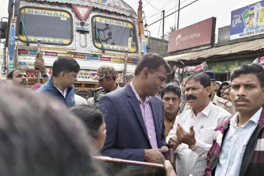 C Murugan (in blue suit) surrounded by voters outside a hearing centre at Mograhat in South 24-Parganas last week.