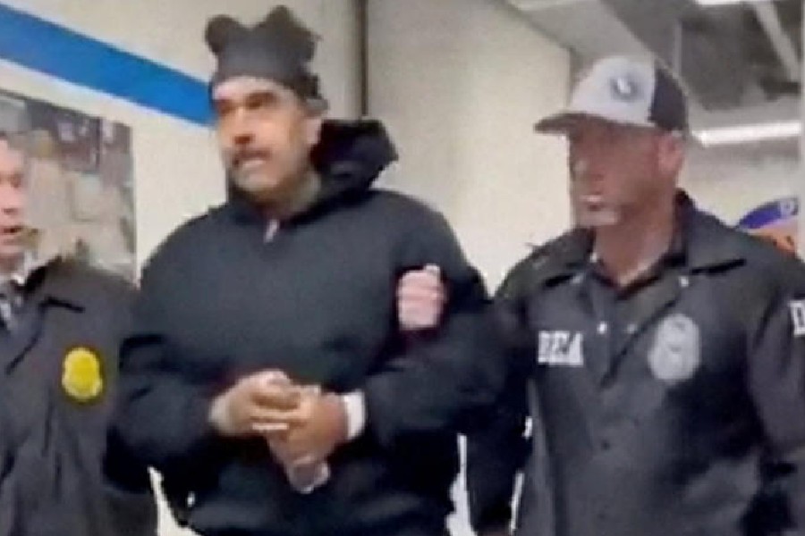 A still image from video posted by the White House's Rapid Response 47 account on X.com, which originated from the @PaulDMauro account, shows Venezuela's President Nicolas Maduro being walked in custody down a hallway at the offices of the U.S. Drug Enforcement Administration (DEA) in New York City, U.S., January 3, 2026.