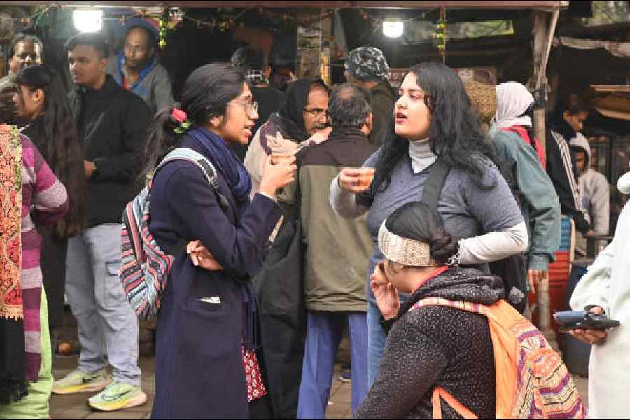 Revellers in front of the Academy of Fine Arts on Sunday afternoon.            Pictures by Bishwarup Dutta and Sanat Kr Sinha