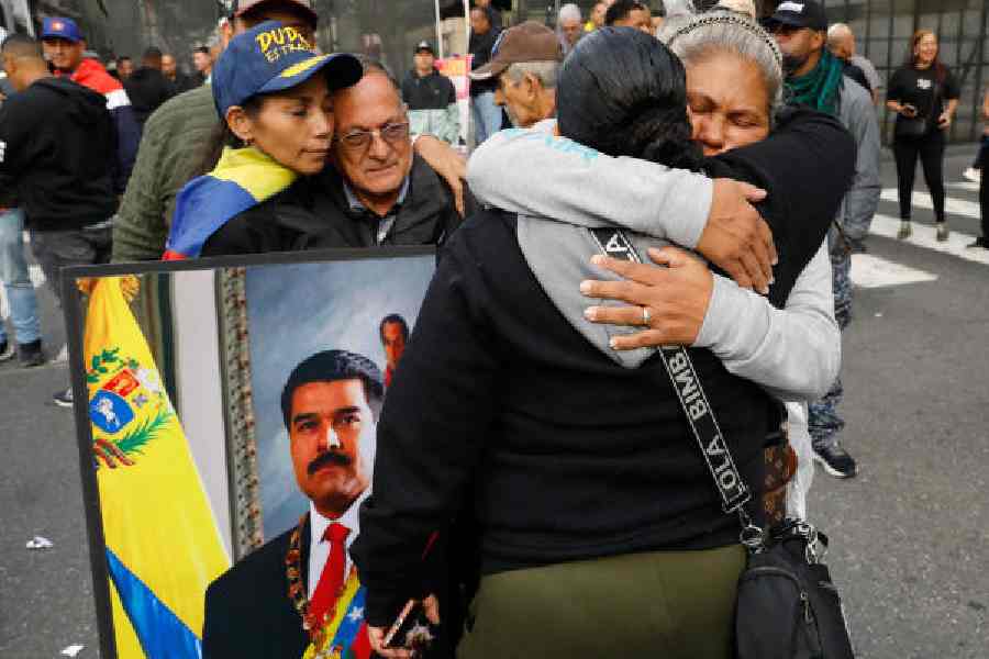 Supporters of Nicolás Maduro embrace in downtown Caracas, Venezuela, on Saturday