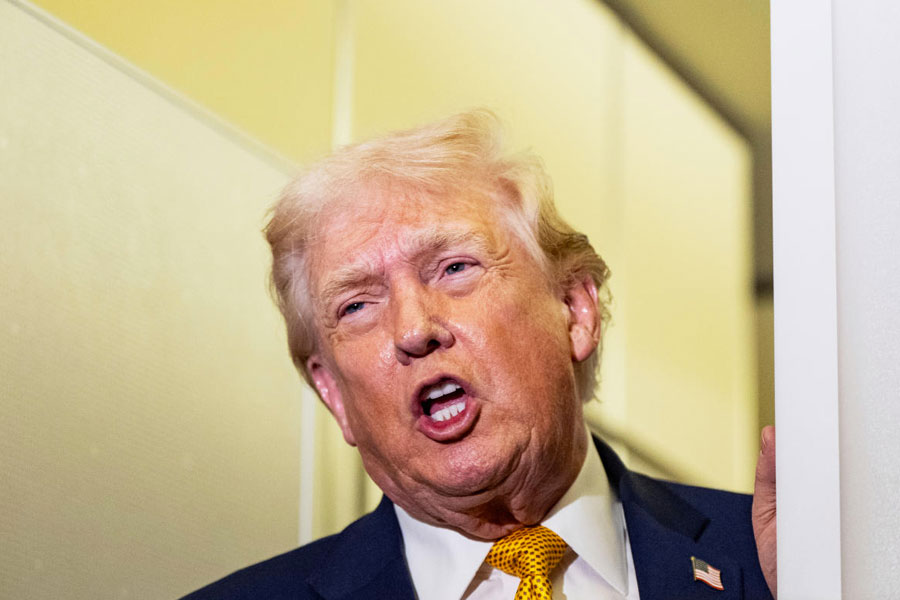 President Donald Trump speaks with reporters while in flight on Air Force One, Sunday, Jan. 4, 2026, as returning to Joint Base Andrews, Md.