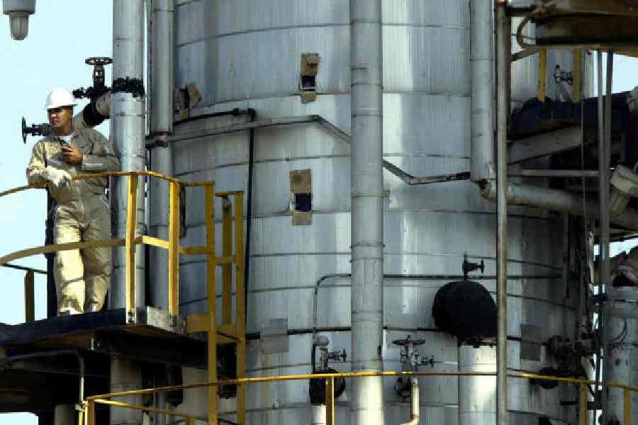 An employee of the state-owned company PDVSA fills an oil tanker at Jose, 321km east of Caracas.  