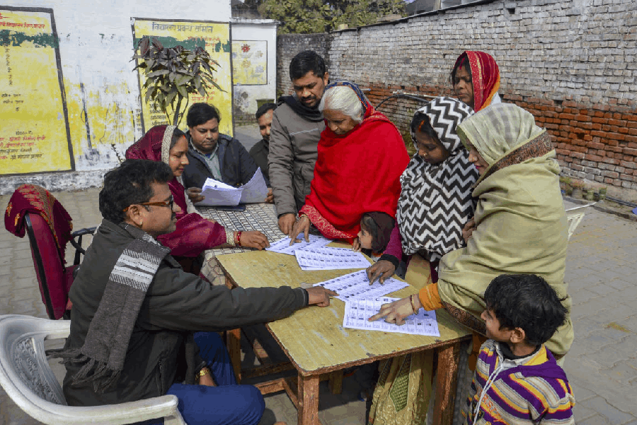 People search for their names in the draft voter list after the Special Intensive Revision of electoral rolls in Uttar Pradesh, in Mirzapur, Uttar Pradesh, Tuesday, Jan. 6, 2026.