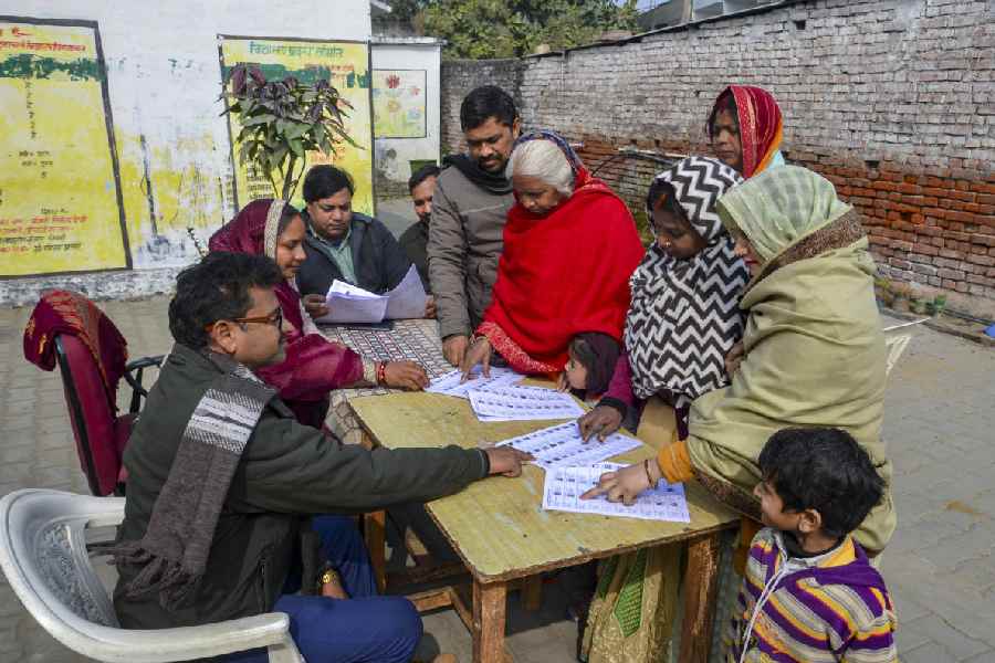 People look for their names in the post-SIR draft roll in Mirzapur on Tuesday.