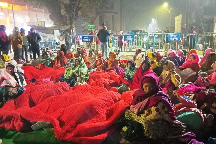 The agitating workers in front of the district magistrate’s office in Alipurduar on Tuesday.