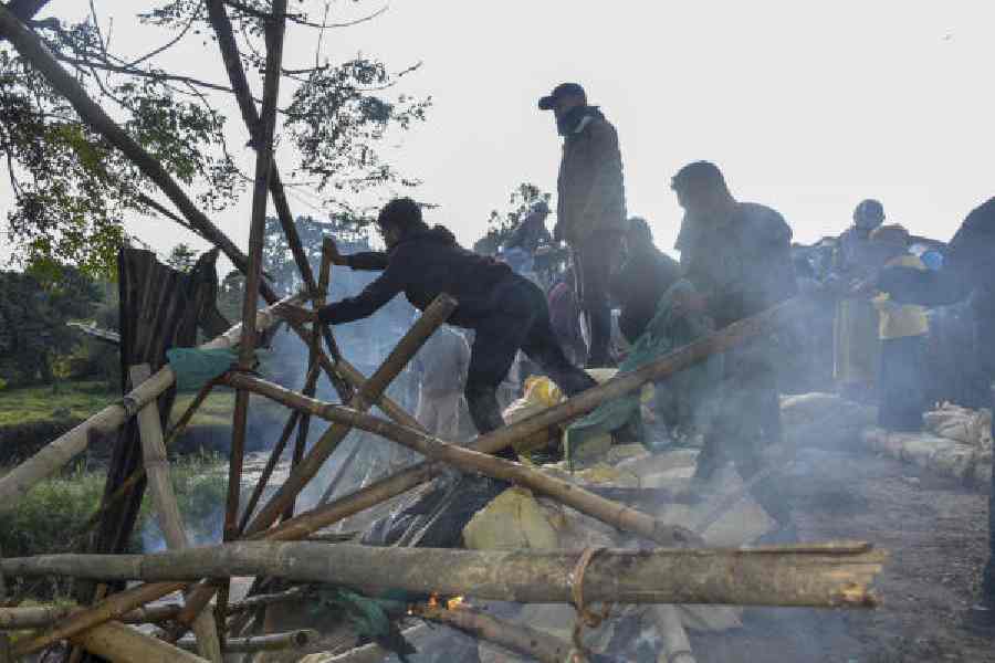 Locals dismantle bunkers of security forces alleging lapses in security in Manipur’s Bishnupur district on Monday. 