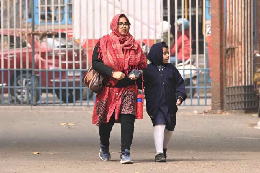A woman accompanies a schoolgirl in the Rabindra Sarobar area on Tuesday morning