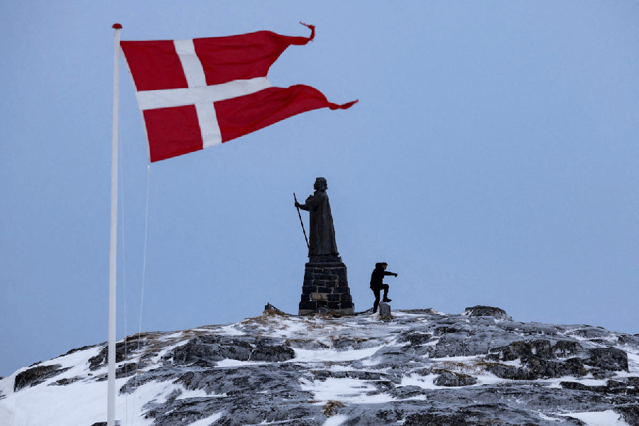 File photo: A man walks as Danish flag flutters next to Hans Egede Statue ahead of a March 11 general election in Nuuk, Greenland, March 9, 2025.
