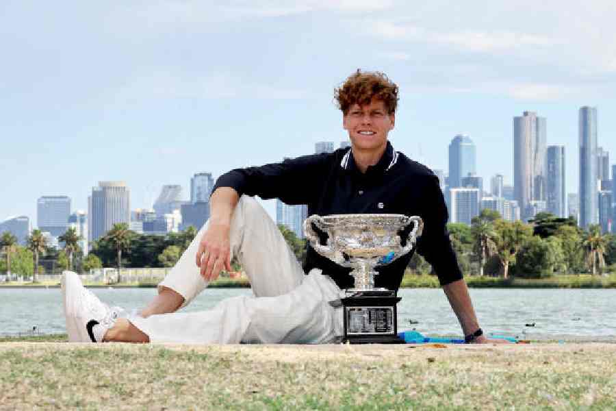 Jannik Sinner poses with the Norman Brookes Challenge Cup in Melbourne on January 27, 2025, the day after he won the Australian Open title for a second time.