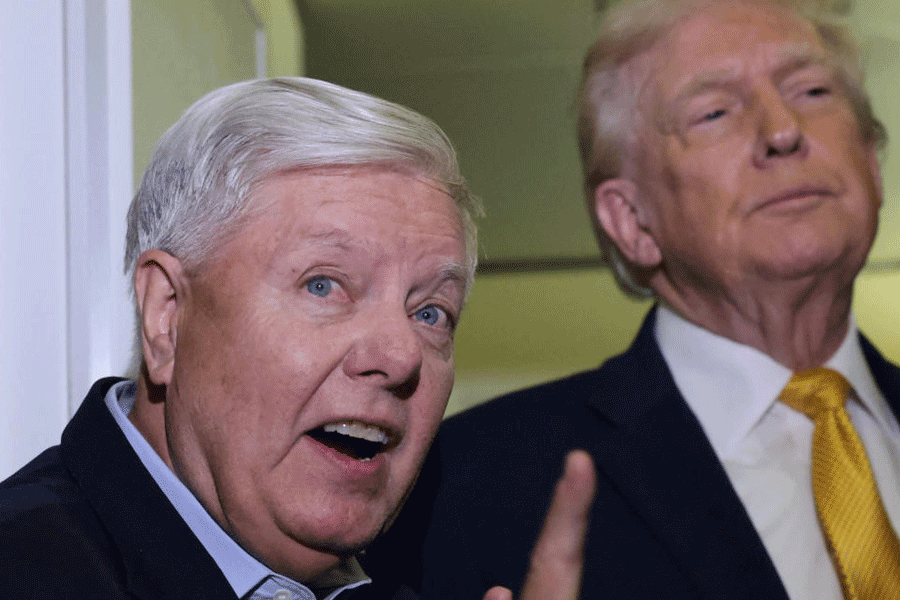 U.S. Senator Lindsey Graham (R-SC) joins President Donald Trump to speak to reporters aboard Air Force One en route from Florida to Joint Base Andrews, Maryland, U.S., January 4, 2026.