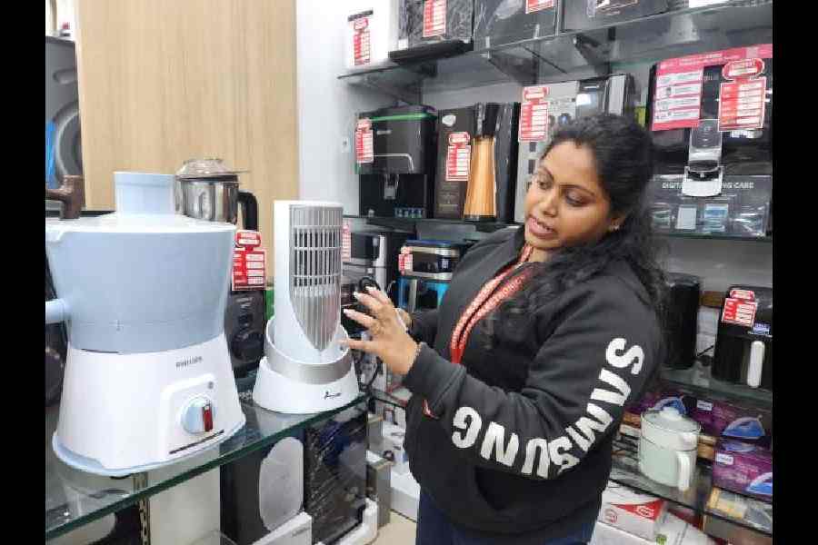 A salesperson at Khosla Electronics explains how a room heater works.