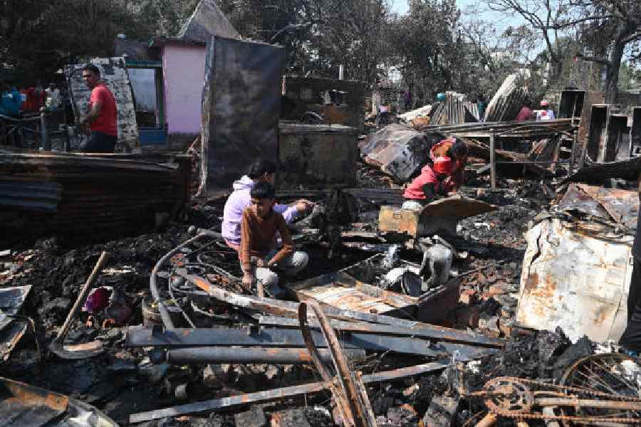 Locals search through the debris a day after a fire gutted Matangini Colony in Nonadanga on Thursday
