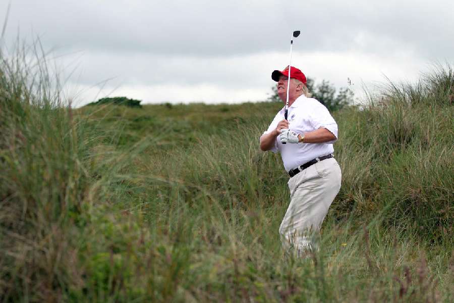 Donald Trump plays a round of golf after the opening of The Trump International Golf Links Course on July 10, 2012 in Balmedie, Scotland.