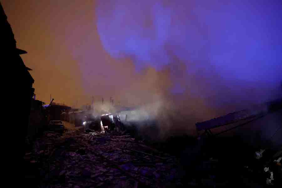 Smoke rises from a compound of car garages damaged during a Russian drone and missile attack, amid Russia's attack on Ukraine, in Kyiv, Ukraine