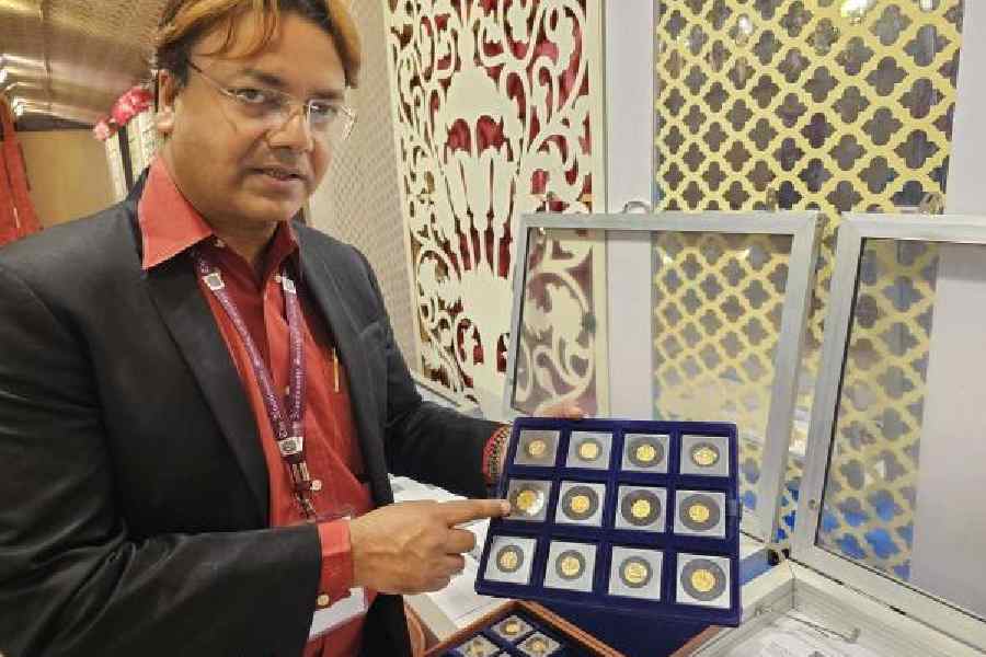 Dr Ujjwal Kumar Saha points to a gold coin in his collection at the exhibition at Mudra Utsav