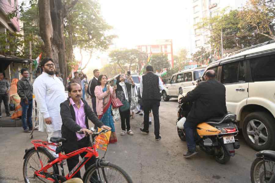 Onlookers wait to catch a glimpse of the rally on Anwar Shah Road