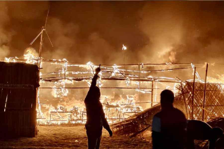 Flames engulf structures at the venue of the Gangasagar Mela on Sagardwip island in South 24-Parganas district on Friday. (PTI picture)