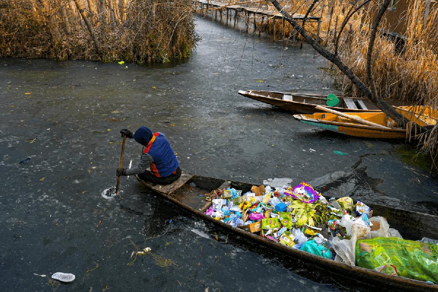 A municipal worker makes his way through a frozen layer of water in interior Dal Lake as the mercury plunges to minus 5.7 degrees Celsius during Chillai Kalan, the 40-day harshest winter period in the Kashmir Valley, in Srinagar, Saturday, Jan. 10, 2026.