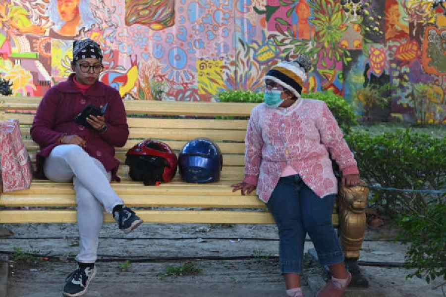 Visitors to Prinsep Ghat braced for a cold Saturday evening. Picture by Sanat Kr Sinha