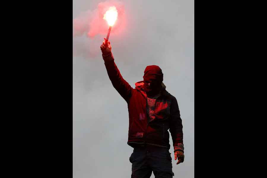 A demonstrator holds a flare during a protest organised by the "Widersetzen" (Resist) alliance to block the founding of a new youth organisation of Germany's far-right Alternative for Germany (AfD) party, in Giessen, Germany.