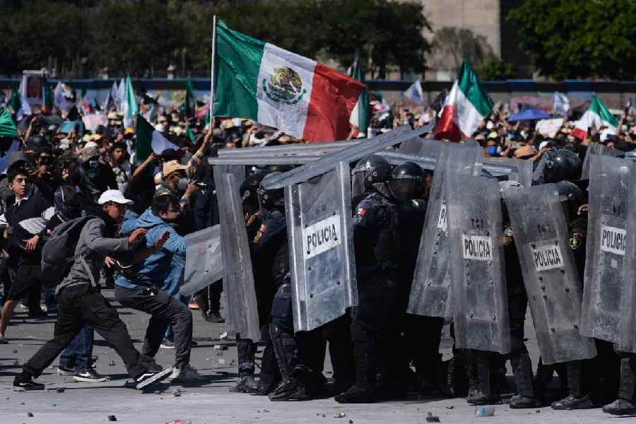 Protesters charge against police during a youth anti-government march in Mexico City, Saturday, Nov. 15, 2025.