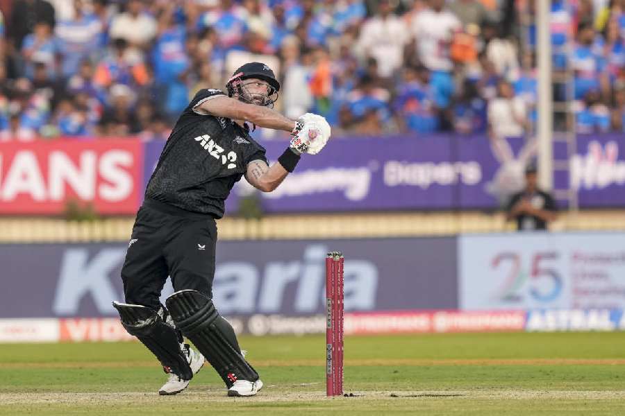 New Zealand's Daryl Mitchell plays a shot during the first ODI cricket match of a series between India and New Zealand, at Kotambi Stadium, in Vadodara, Gujarat, Sunday