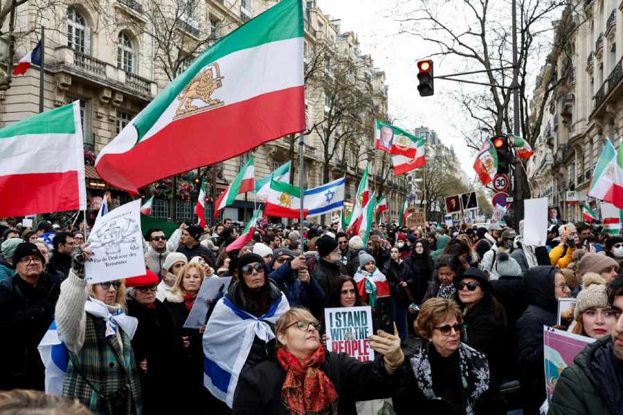 Demonstrators and activists hold "Lion and Sun" pre-Iranian Revolution national flags during a rally in support with Iranian people amid anti-government protests raging across Iran