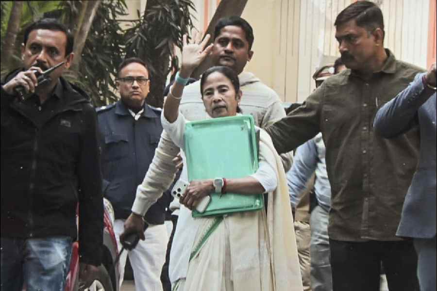 Mamata Banerjee holds the green folder that she took from Pratik Jain’s home on Thursday.