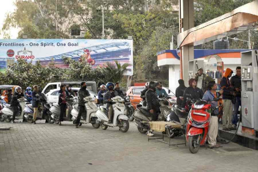 People wait in queues to buy fuel at a gas station in Imphal on Friday, a day after the bomb attack. 