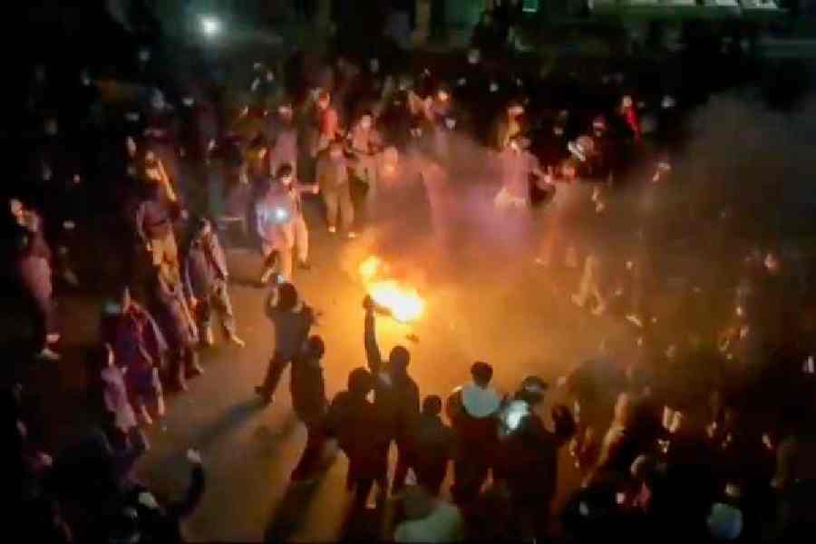 Protesters dance around a bonfire in Tehran on Friday as they take to the streets despite an intensifying crackdown by the Iranian regime.