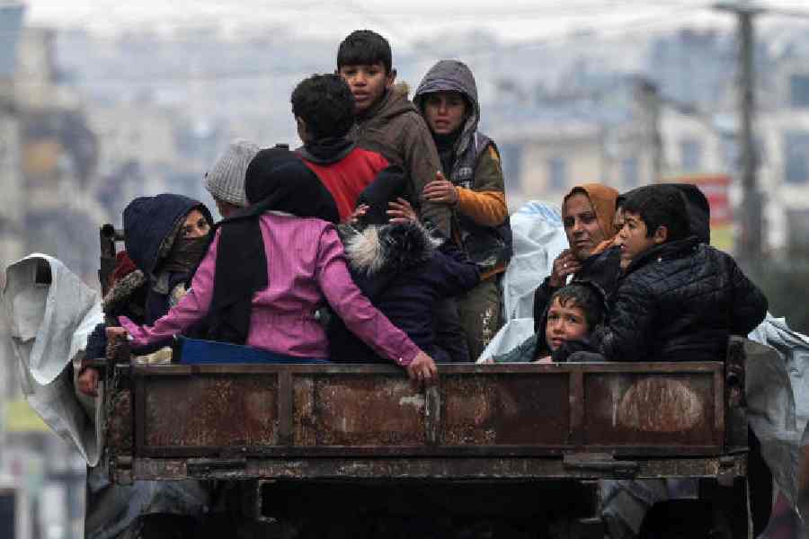 People on the back of a vehicle in the Ashrafieh neighbourhood of Aleppo, Syria, on Sunday.