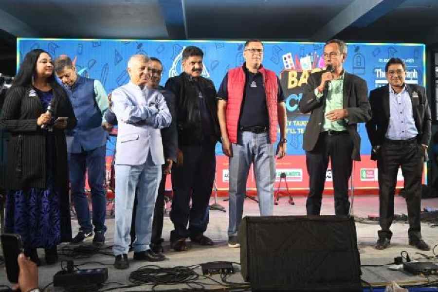 The launch of the Aspexs Global Chapters with secretary Meghnath Roy Chowdhury (in jacket), other organisers and overseas Pointers;            (right) the Class of 1976 cuts a cake to mark 50 years of school-leaving. Pictures by Sanat Kumar Sinha