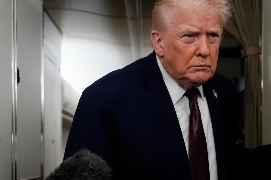 President Donald Trump speaks to reporters while in flight on Air Force One to Joint Base Andrews, Md., Sunday, Jan. 11, 2026.