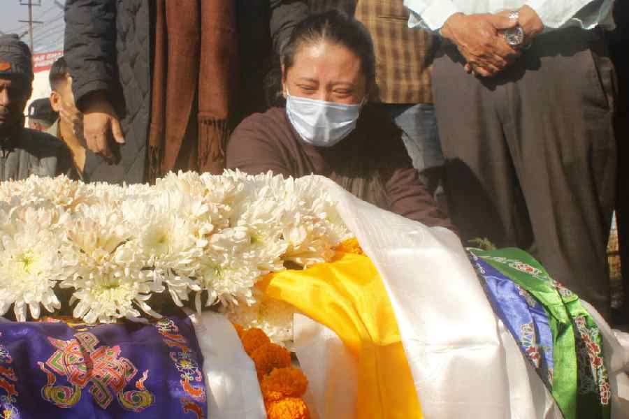 Deceased Prashant Tamang’s wife Geeta Thapa (wearing a mask) at the Bagdogra Airport with his mortal remains on Monday