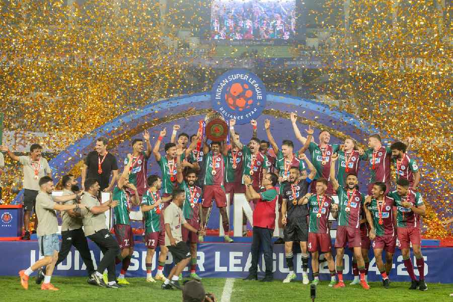 Mohun Bagan Super Giant players celebrate with the ISL Cup at the Salt Lake Stadium on April 12, 2025. Bagan, who scored a double last season by winning the Shield and the Cup, have told the AIFF that they will play their home matches at the Salt Lake Stadium.