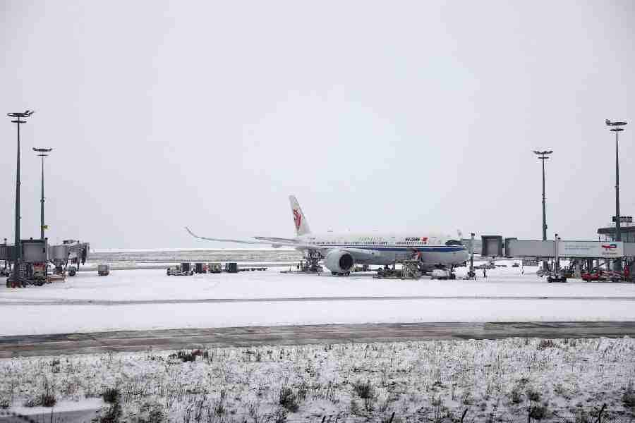 An Air China plane is seen on the snow-covered tarmac at the Paris CDG Terminal 1 of the Paris-Charles de Gaulle Airport, in Roissy-en-France, near Paris, as traffic is disrupted and some flights cancelled due to winter weather with snow and cold temperatures hitting a part of the country, France, January 7, 2026.