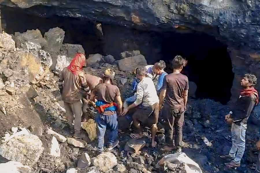 Workers during a rescue operation following a shaft collapse during alleged illegal coal mining, at an open-cast mine in Asansol