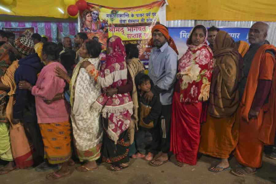 Gangasagar Mela pilgrims in a queue at a transit            camp at Babughat on Tuesday. (PTI picture)