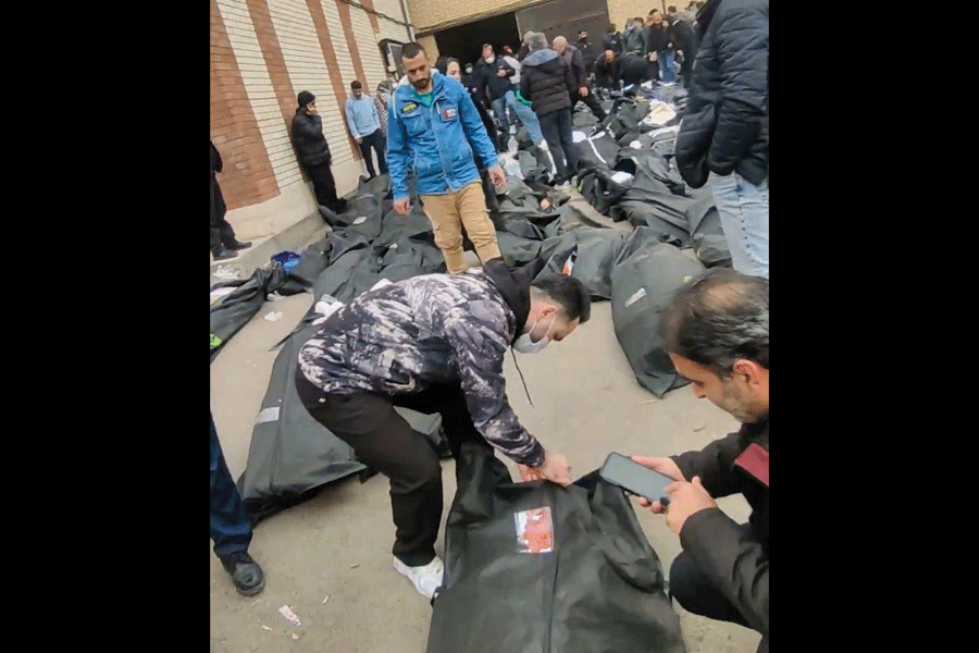 This frame grab from videos taken between Jan. 9 and Jan. 11, 2026, and circulating on social media purportedly shows people trying to identify remains among dozens of bodies after a crackdown at a morgue on the outskirts of Iran's capital, in Kahrizak, Tehran Province.